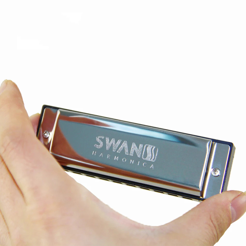 Diatonic harmonica with a blues design in metal, accompanied by a brass case.