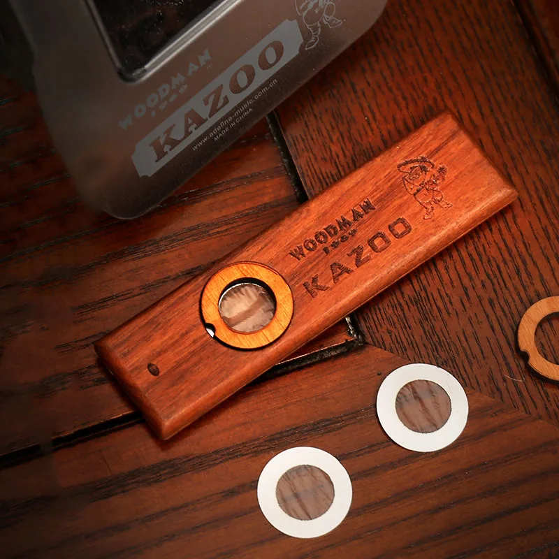 Details of a wooden kazoo in a metal case