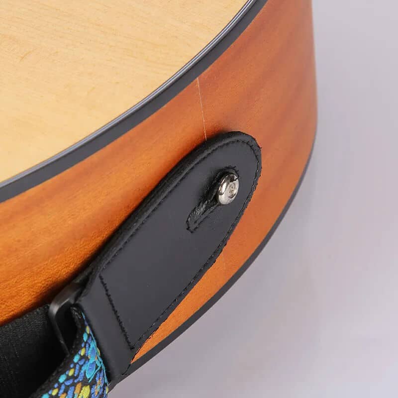 Details of fabric strap fastening with a blue embroidered floral pattern