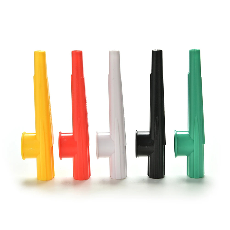 Full view of a small, randomly colored plastic kazoo.