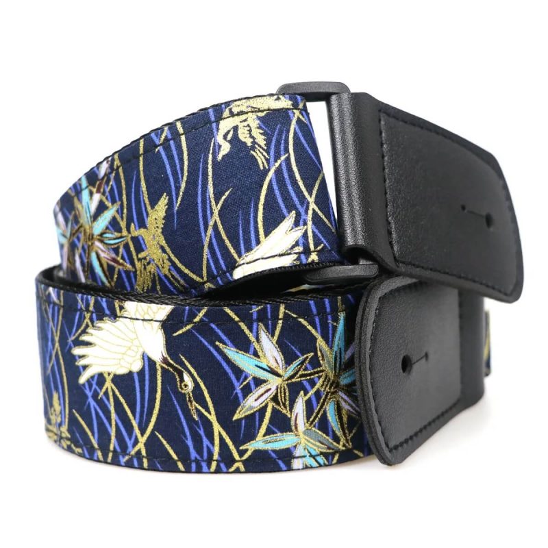 Details of a Japanese-inspired guitar strap featuring a flying crane design in blue color.