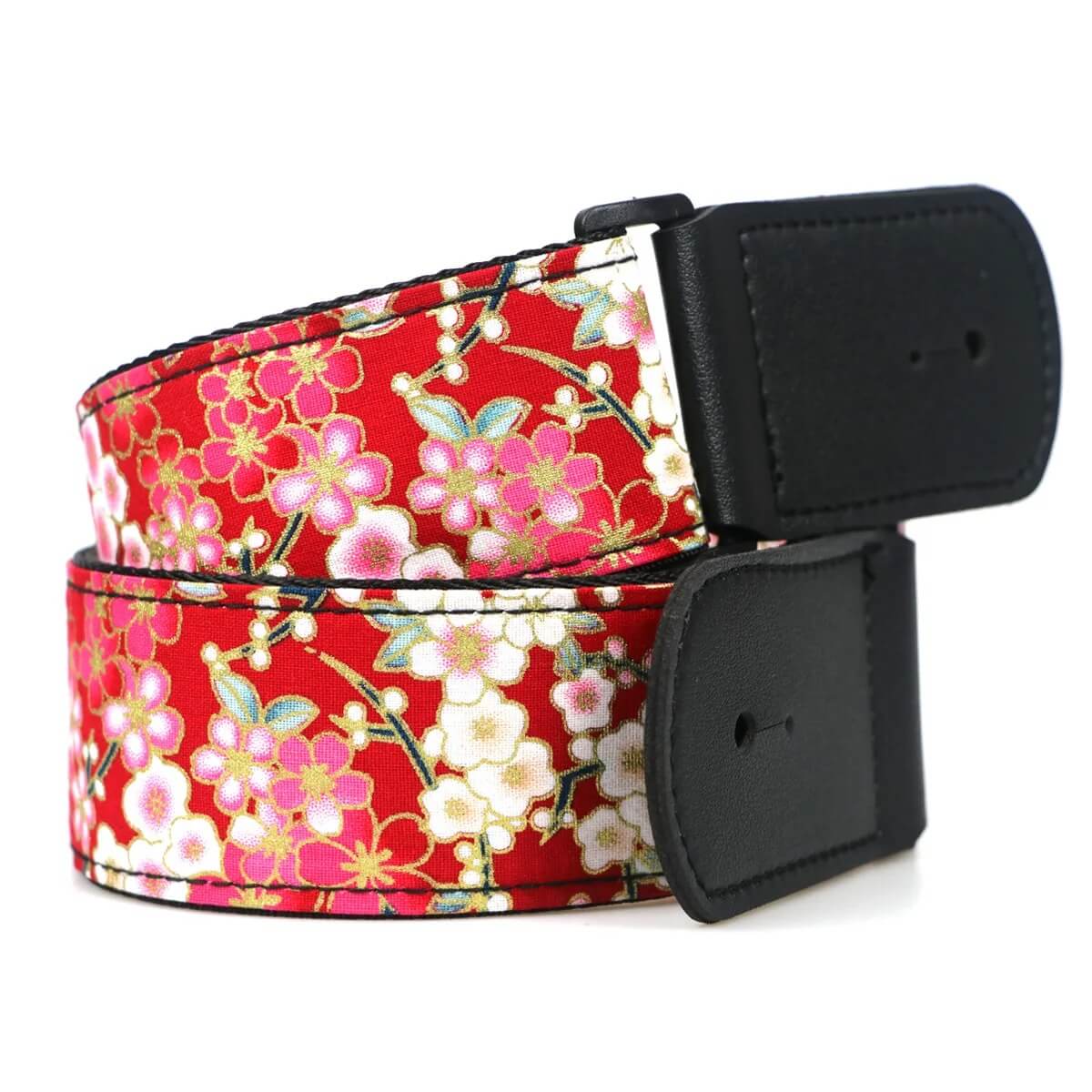 Details of an electric guitar strap with a Japanese-inspired Sakura flower print.