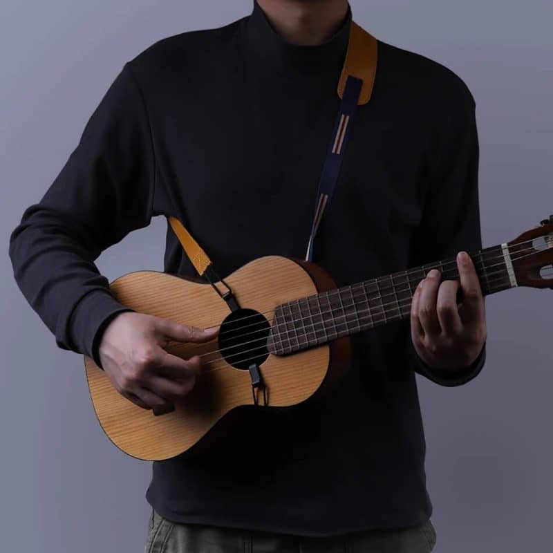 Very thin ukulele strap with shoulder pad, seen worn
