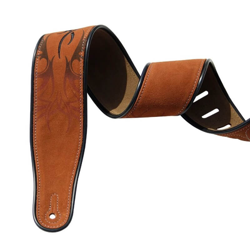 Details of stitching on a light brown suede guitar strap with a tribal pattern