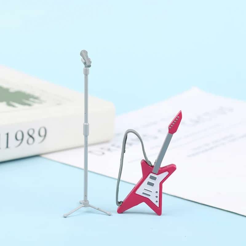 Magnificent miniature pink star electric guitar with microphone