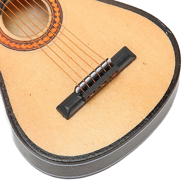 Detailed view of a realistic wooden miniature acoustic guitar for hanging.