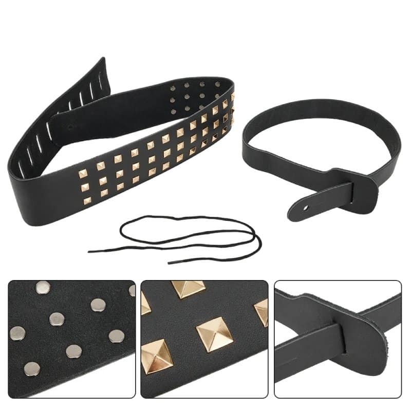 Details of a black leather guitar strap with pyramid-shaped claw studs, death metal style.