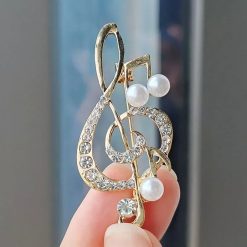 Treble Clef brooch adorned with rhinestones and pearls