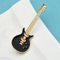 Enamel brooch of a black and gold electric guitar