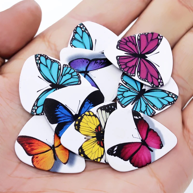 Detailed view of a set of 10 picks with colorful butterfly designs - 3 thicknesses available