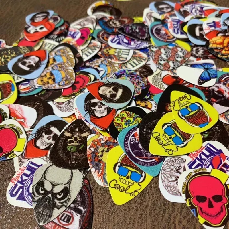Set of 10 guitar picks with skull and death's head motifs.