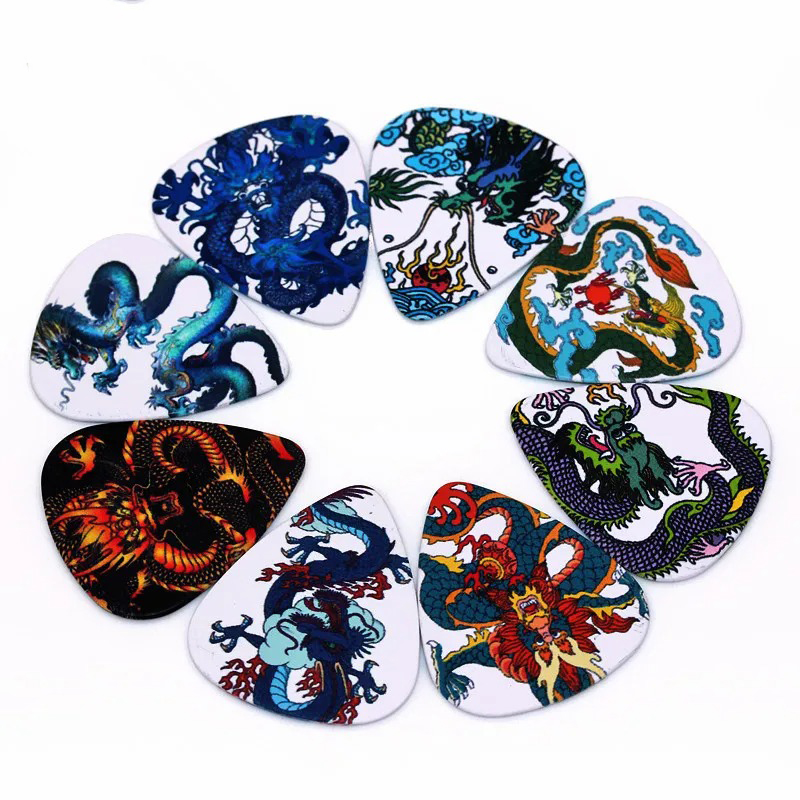 Full view of a set of 10 guitar picks with dragon motifs.