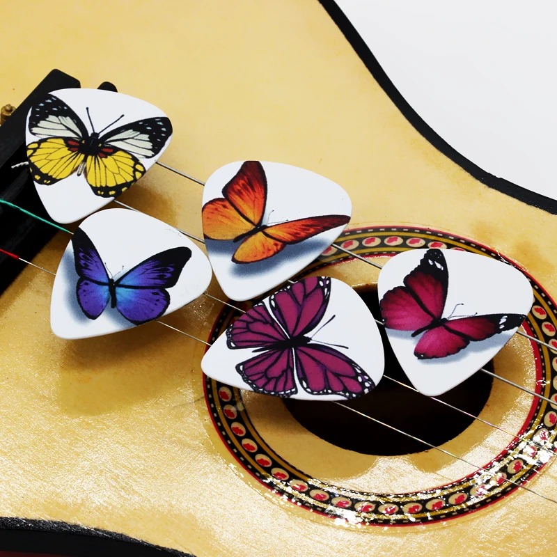 Set of 10 picks with colorful butterfly designs, available in different thicknesses.