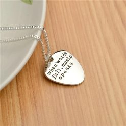 Plectrum-shaped medallion with the phrase "When words fail, music speaks".