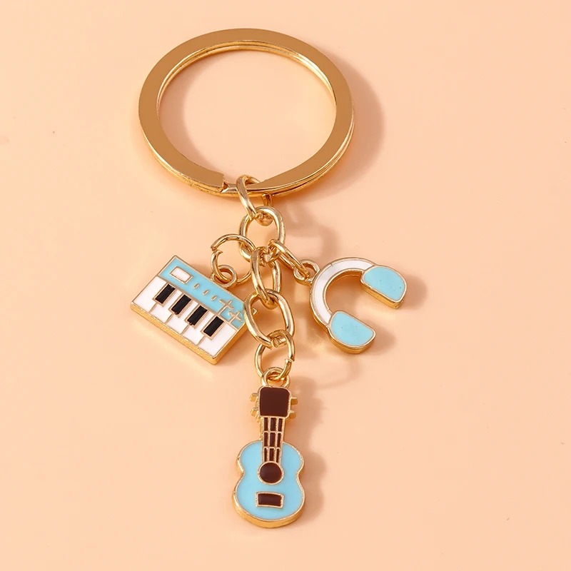 Blue metal keychain of a guitar and musical instruments