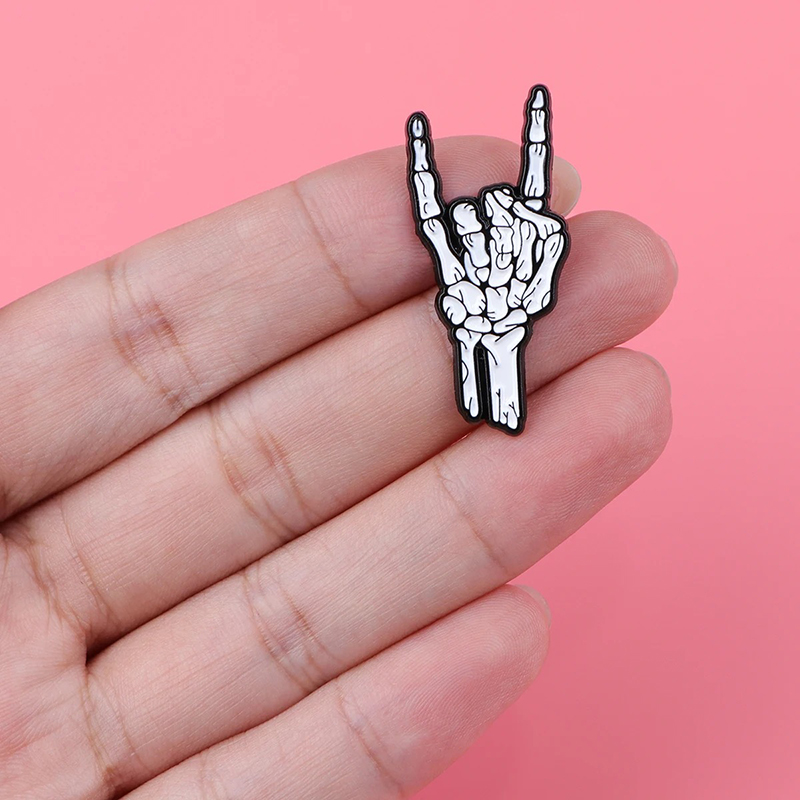 Details of the Enamel Pin of Skeleton Hand making the Horns Sign