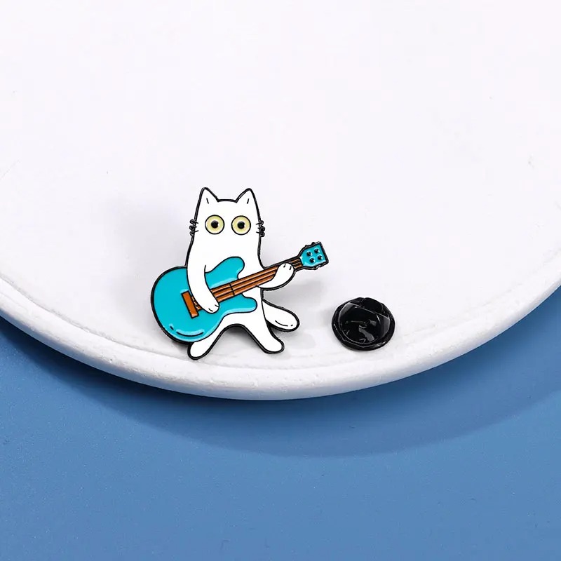 Enamel pins of a Cat playing the Guitar