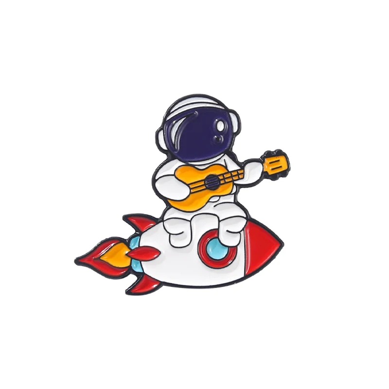 Enamel pins of a Cosmonaut playing the guitar on a rocket