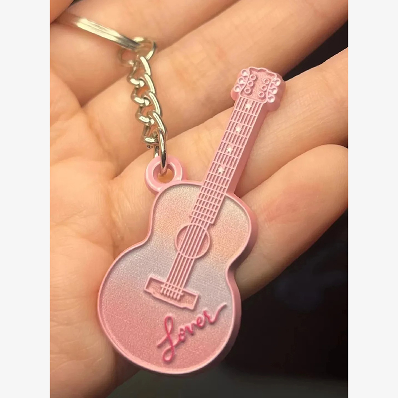 Pink guitar keychain with the inscription "Lover".