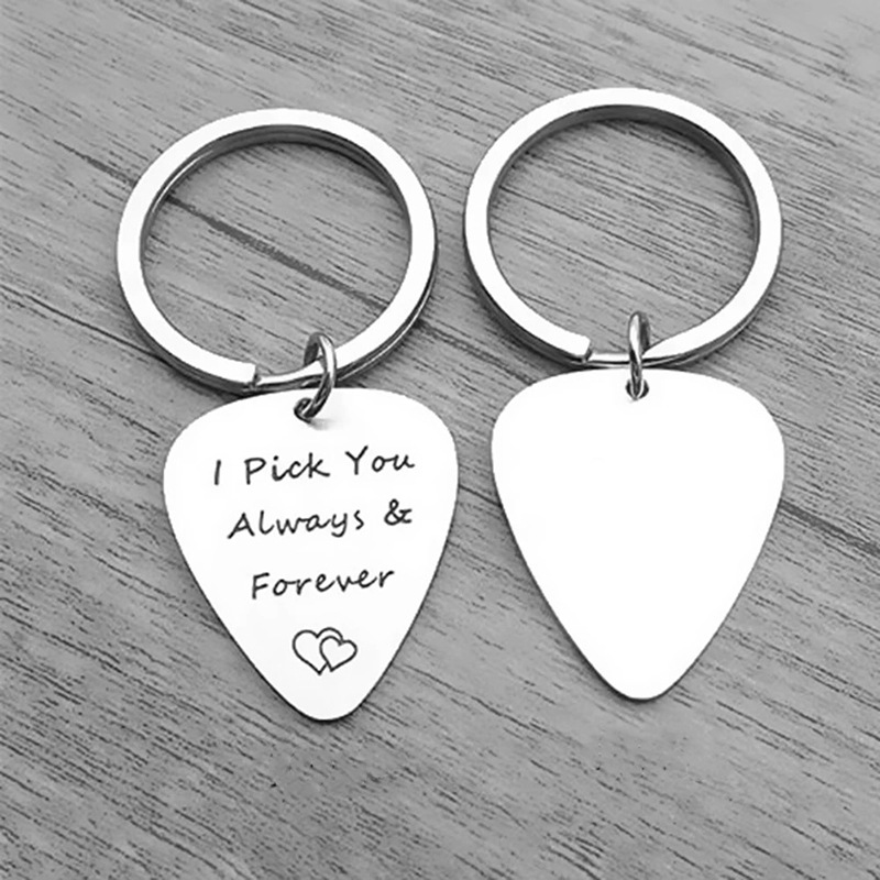 Front and back view of a guitar pick keychain with a love message