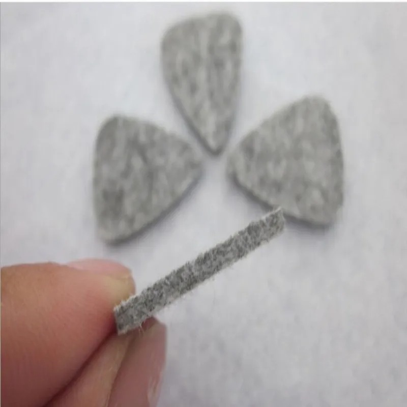 Details of a set of 4 soft felt picks in assorted colors for ukulele.