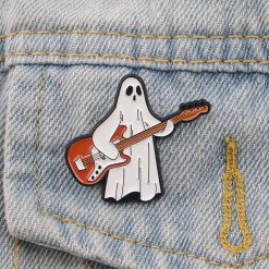 Enamel Pins of a Small Ghost Playing the Guitar