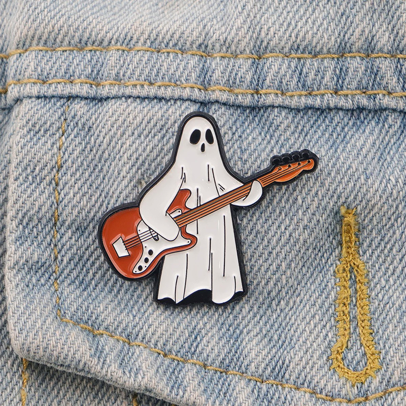 Enamel Pins of a Small Ghost Playing the Guitar