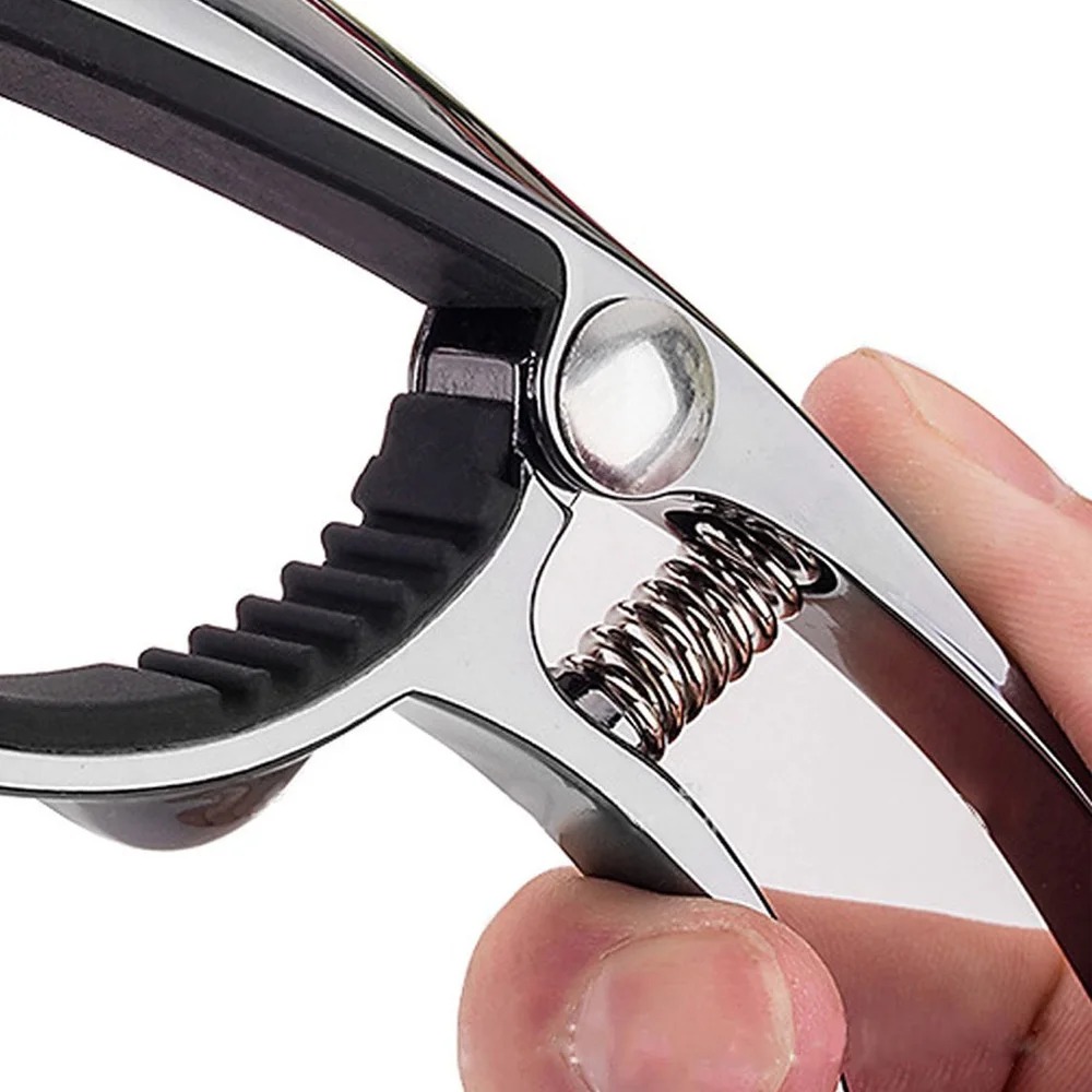 Detailed view of a metal capo made from zinc alloy in the shape of a steel-colored leopard.