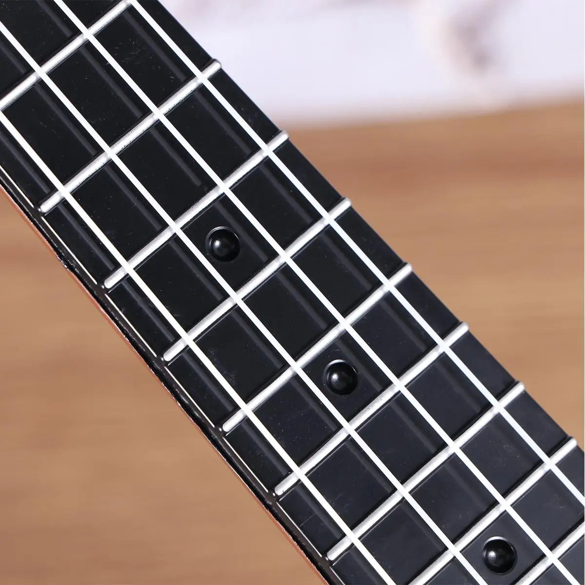 Details of the strings of a child's ukulele, a perfect instrument for toddlers