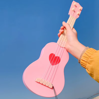 Small guitar for children, suitable for either a girl or boy - pink in color