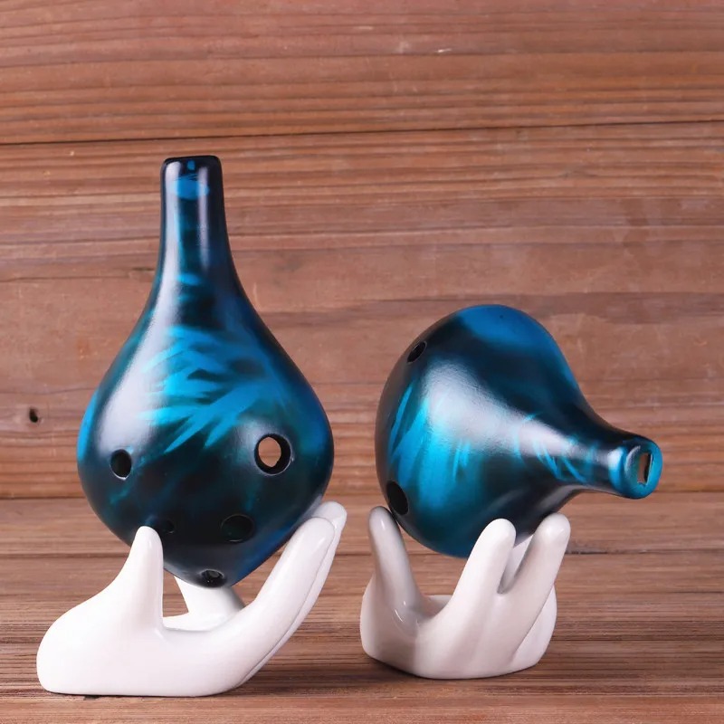 Strawfire style ceramic ocarina with 6 holes in C tone, colored.