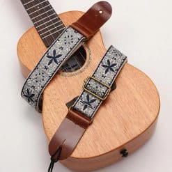 General view of the vintage ukulele strap with bohemian flowers on starry blue