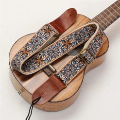 Overall view of the vintage-style ukulele strap with bohemian flowers in blue and ochre.